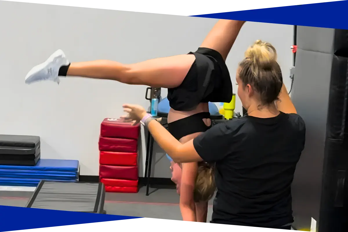 Coach spotting a tumbling athlete through a back walkover at Genesis Athletix