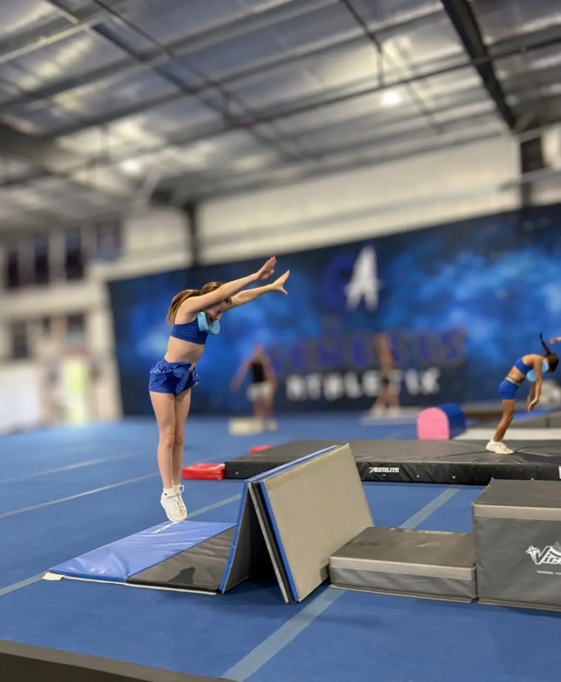 Young athlete practicing a tumbling pass at Genesis Athletix in Fort Wayne